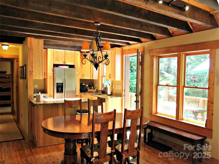 142 Cherrywood Lane, Pisgah Forest, NC 28768.  MLS# CAR4312423, YatesRealty ID 13342. Dinning area looking toward the kitchen and out the windows to the back deck.