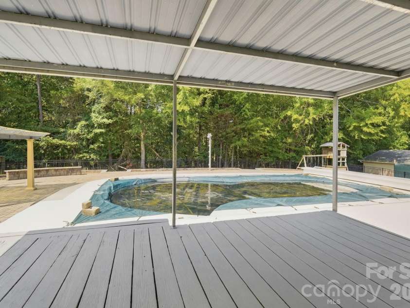 213 Lakeview Drive, Harrisburg, NC 28075.  MLS# CAR4426223, YatesRealty ID 13351. Backyard patio & Pool