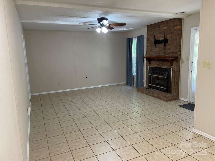 424 Creekside Drive, Asheville, NC 28804.  MLS# CAR4259883, YatesRealty ID 13362. Family room viewed from kitchen dining area. Open concept.