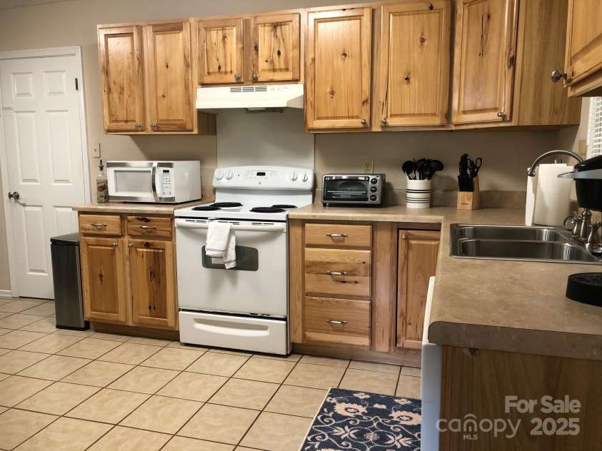 424 Creekside Drive, Asheville, NC 28804.  MLS# CAR4259883, YatesRealty ID 13362. Kitchen and door to laundry