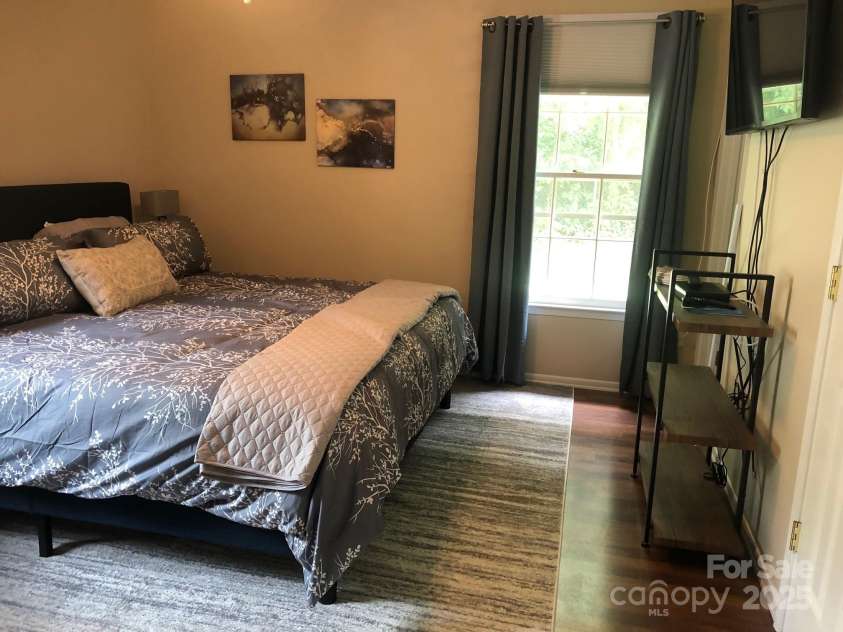 424 Creekside Drive, Asheville, NC 28804.  MLS# CAR4259883, YatesRealty ID 13362. Master bedroom with king bed. Home is now vacant.