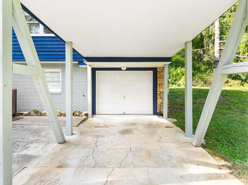 217 Royal Pines Drive, Arden, NC 28704.  MLS# CAR4257398, YatesRealty ID 13374. Carport and a one car garage