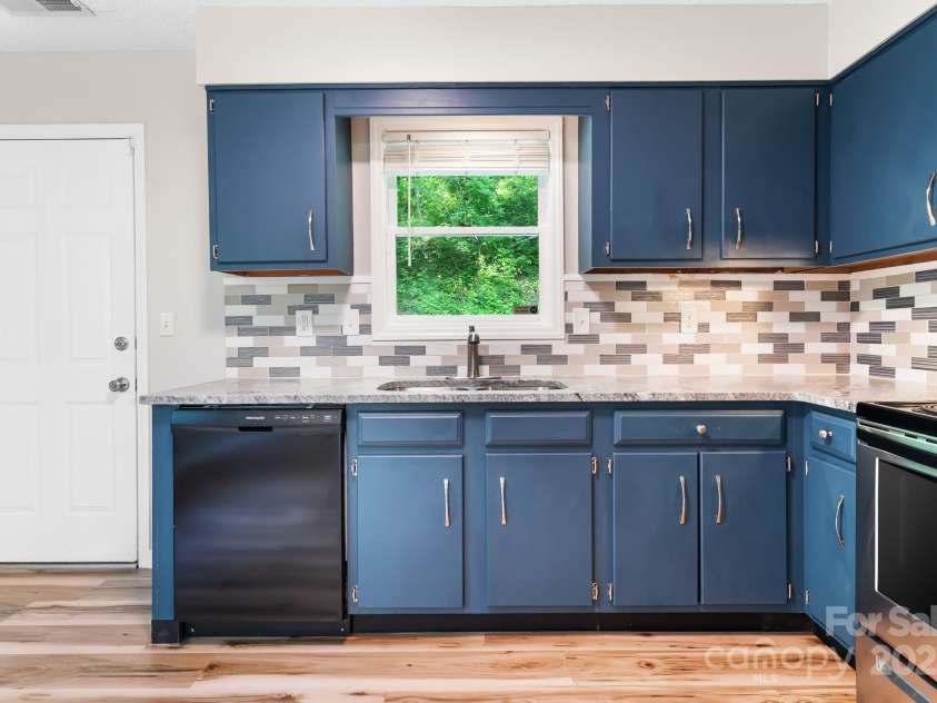 217 Royal Pines Drive, Arden, NC 28704.  MLS# CAR4257398, YatesRealty ID 13374. Kitchen door leads to back deck