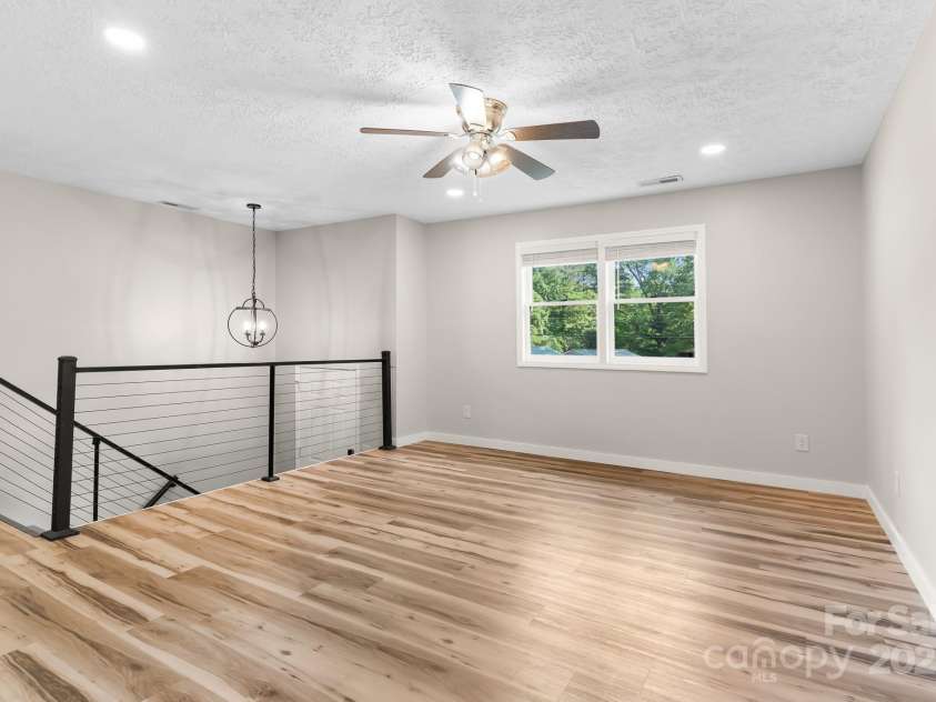 217 Royal Pines Drive, Arden, NC 28704.  MLS# CAR4257398, YatesRealty ID 13374. Living room looking towards entry stairs