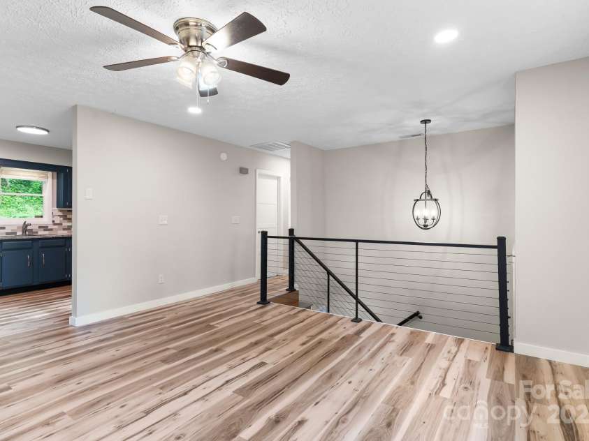 217 Royal Pines Drive, Arden, NC 28704.  MLS# CAR4257398, YatesRealty ID 13374. Looking from the living room towards the kitchen, and the hallway leading to bedrooms and baths
