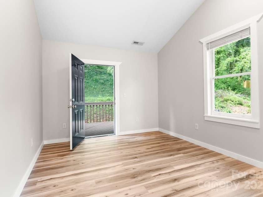 217 Royal Pines Drive, Arden, NC 28704.  MLS# CAR4257398, YatesRealty ID 13374. Primary bedroom. Far door opens onto rear