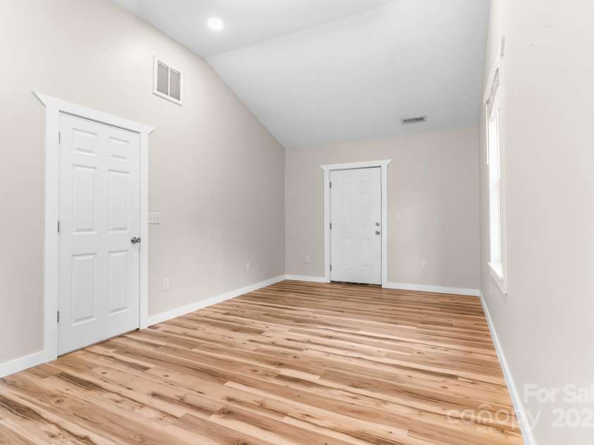 217 Royal Pines Drive, Arden, NC 28704.  MLS# CAR4257398, YatesRealty ID 13374. Primary bedroom. Far door opens onto rear deck