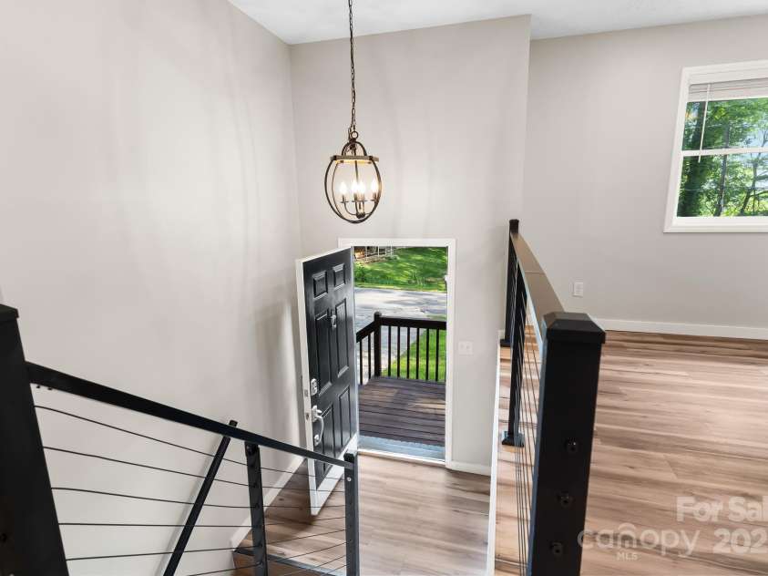 217 Royal Pines Drive, Arden, NC 28704.  MLS# CAR4257398, YatesRealty ID 13374. The front entry leads up to an open living/dining area