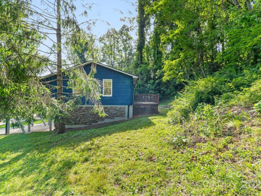 217 Royal Pines Drive, Arden, NC 28704.  MLS# CAR4257398, YatesRealty ID 13374. View of right side of home from neighboring property