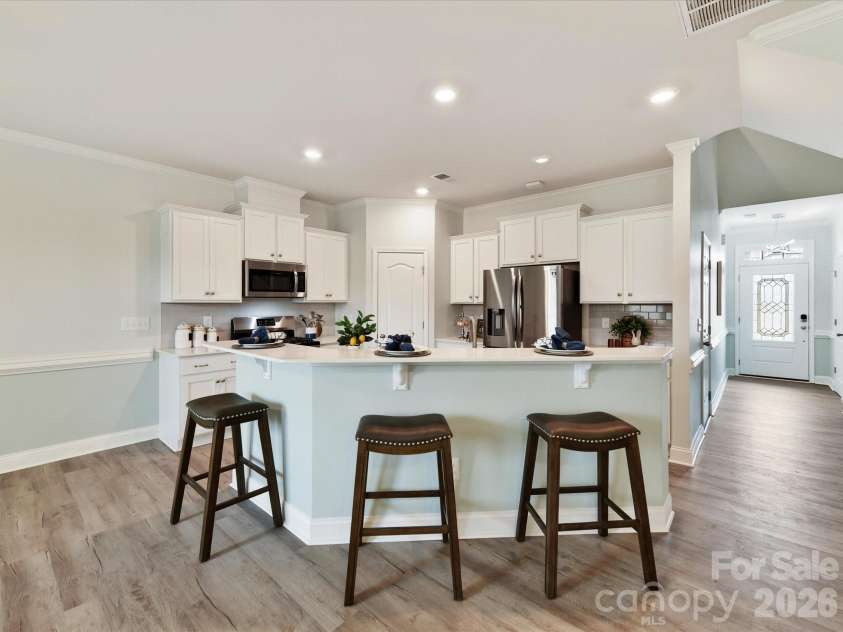 5218 Spanish Ivy Lane, Indian Land, SC 29707.  MLS# CAR4359918, YatesRealty ID 13379. Efficient Kitchen with White Cabinets, Subway Tiled Backsplash and Quartz Counters