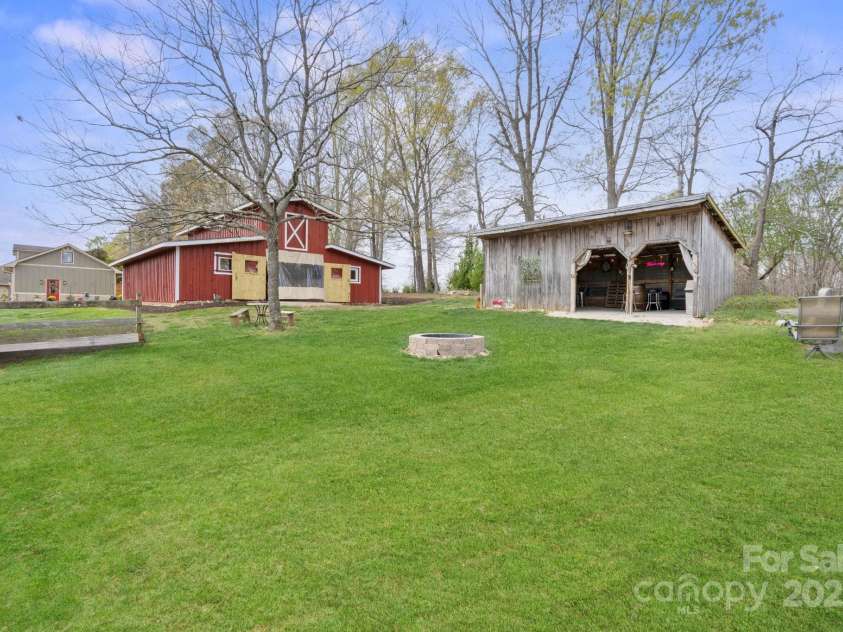 1620 London Road, Mooresville, NC 28115.  MLS# CAR4281112, YatesRealty ID 13387. Party Barn, a party bar, grassy picnic area, and fire pit area.