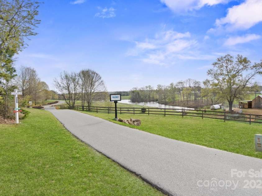 1620 London Road, Mooresville, NC 28115.  MLS# CAR4281112, YatesRealty ID 13387. Picturesque, windy private street leads to the estate.