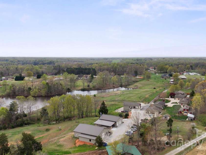 1620 London Road, Mooresville, NC 28115.  MLS# CAR4281112, YatesRealty ID 13387. The property includes a total of nine structures:A 28x36 Welcome Center with a lower-level garage/storage area of the same size. A 40x50 Paint Shop featuring a fully enclosed paint booth, a 16x35 wash bay, and a 28x48 c