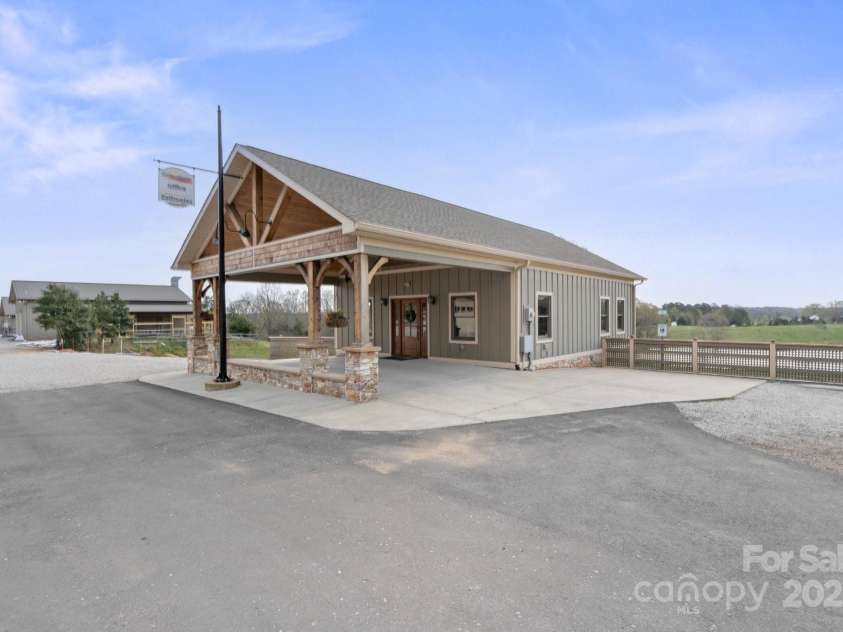 1620 London Road, Mooresville, NC 28115.  MLS# CAR4281112, YatesRealty ID 13387. This is the main reception area for the current business, Color Master Collision Center. This shop has a reception area, 2 offices, kitchenette, bathroom, living area with a stacked stone fireplace. It also has a huge g