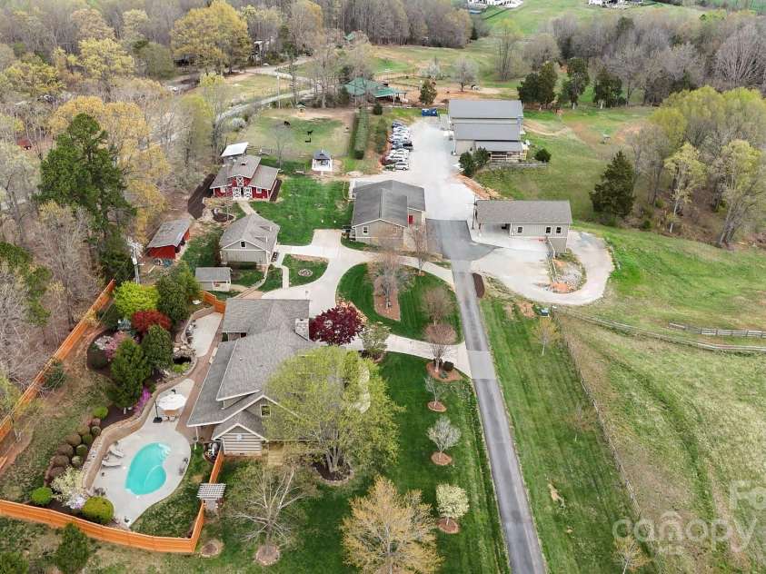 1620 London Road, Mooresville, NC 28115.  MLS# CAR4281112, YatesRealty ID 13387. This showcases many of the improvements to the property including the main home, the pool, the guest house, the event barn, the party barn, and the 4 top of the line garages/shops.