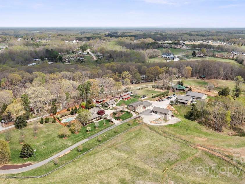 1620 London Road, Mooresville, NC 28115.  MLS# CAR4281112, YatesRealty ID 13387. Welcome to London Road Estates — 22 acres of peace, privacy, and prosperity. At the heart of the property sits a stunning Hearthstone Log Home, complete with a pool, offering rustic luxury and modern comfort. Nearby, a 