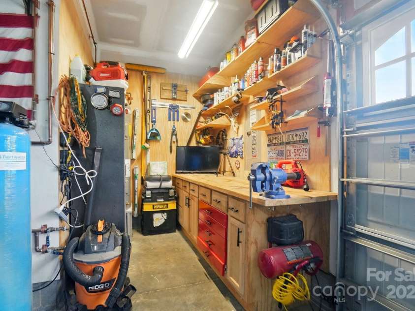 6314 Bluffton Lane, Midland, NC 28107.  MLS# CAR4256231, YatesRealty ID 13390. Convenient workshop area in the garage with a sink.