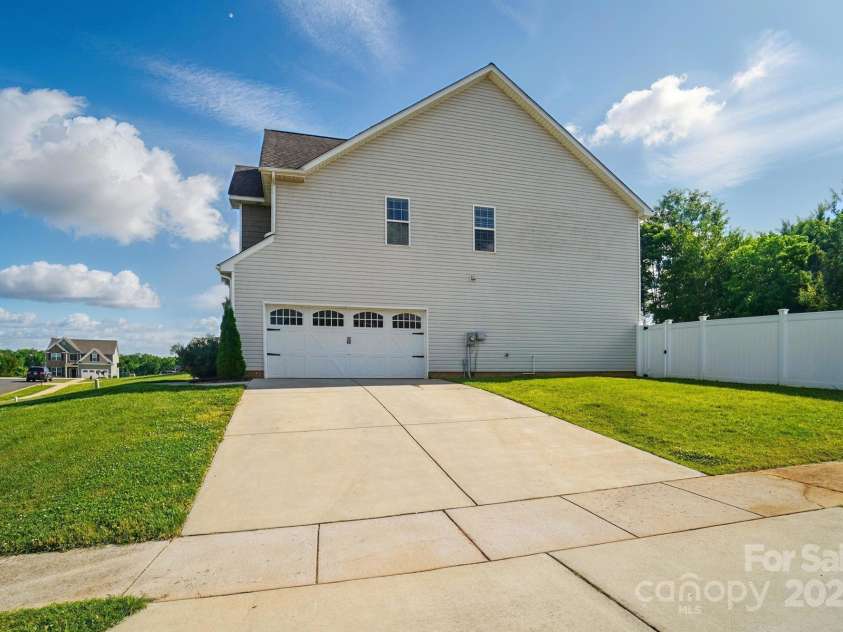 6314 Bluffton Lane, Midland, NC 28107.  MLS# CAR4256231, YatesRealty ID 13390. Side load garage.