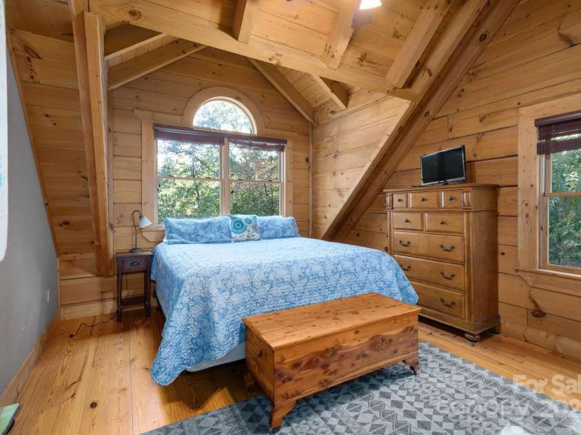117 Laurel Lakes Parkway, Lake Lure, NC 28746.  MLS# CAR4182403, YatesRealty ID 1340. Upstairs primary bedroom