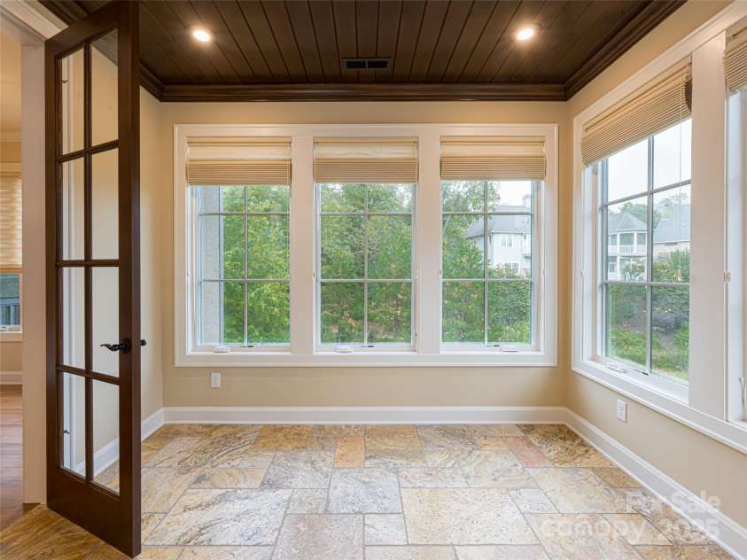 87 Chantilly Drive, Asheville, NC 28804.  MLS# CAR4306861, YatesRealty ID 13417. The sunroom could be a lovely light filled office