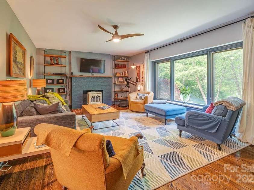 2102 Walnut CreeK Road, Marshall, NC 28753.  MLS# CAR4235544, YatesRealty ID 13420. Living Room with a Jotul Gas Stove