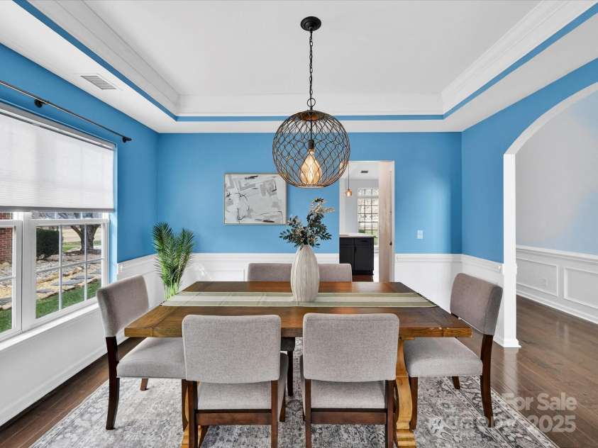 15815 Lavenham Road, Huntersville, NC 28078.  MLS# CAR4328417, YatesRealty ID 13422. Formal Dining Room features tray ceiling, custom light fixture, wainscoting & crown molding!