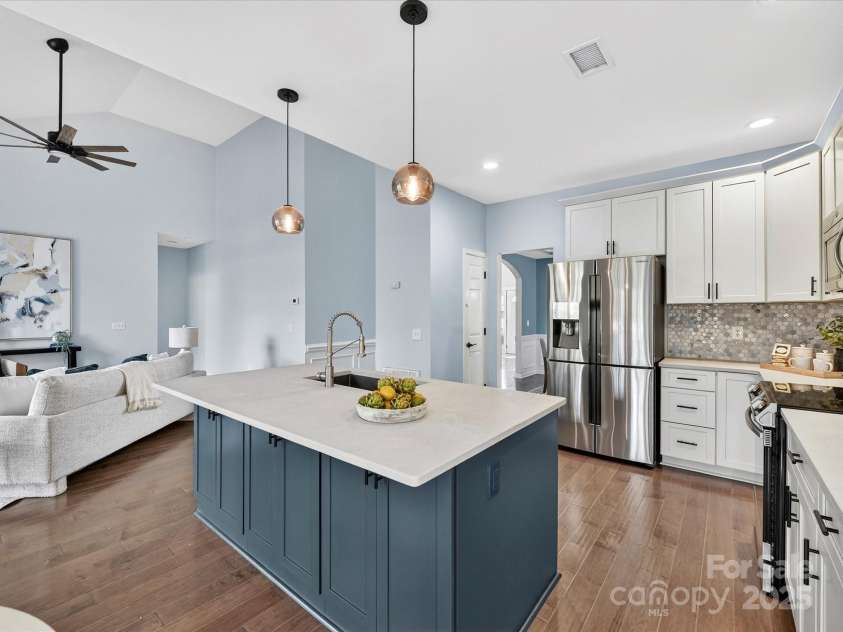 15815 Lavenham Road, Huntersville, NC 28078.  MLS# CAR4328417, YatesRealty ID 13422. Upgraded Kitchen offers quartz counters, stainless steel appliances (including Refrigerator to remain), custom back splash, large island with storage/seating, custom lighting, plenty of cabinetry, pantry & breakfast