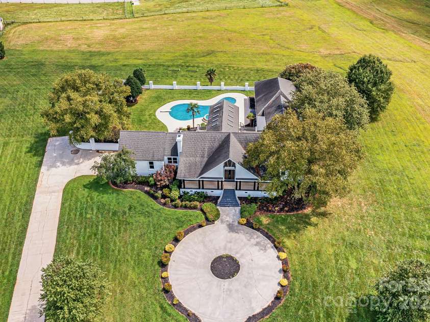 3245 Jackson Road, Mooresville, NC 28115.  MLS# CAR4161494, YatesRealty ID 13432. Aerial view of Spectacular, Custom, Modern, 2 Story Home with 2 Car Side Load Garage, Expansive Pool/Spa, located on 14 sprawling acres of level pasture land & surrounded by Equestrian properties!