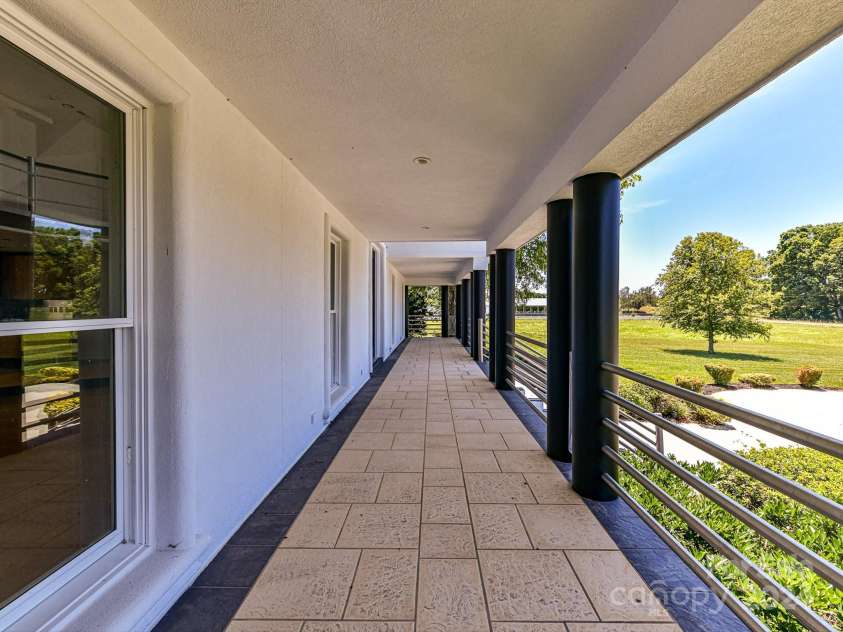 3245 Jackson Road, Mooresville, NC 28115.  MLS# CAR4161494, YatesRealty ID 13432. Covered Front porch covers length of home!