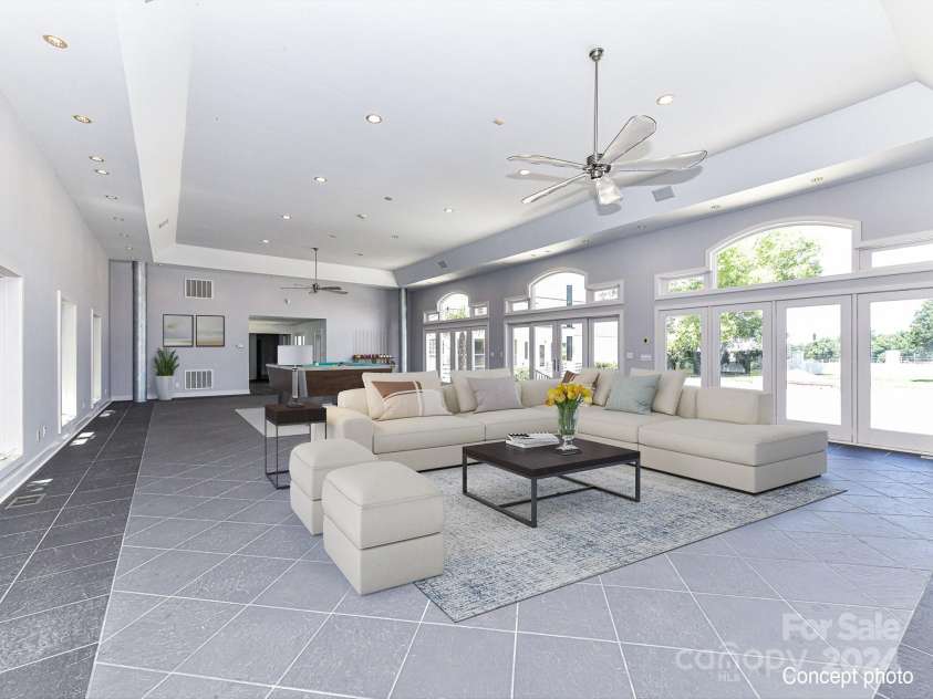 3245 Jackson Road, Mooresville, NC 28115.  MLS# CAR4161494, YatesRealty ID 13432. Recreation Room on main level with recessed lights, ceiling fan, tile floors, walls of windows & patio access!