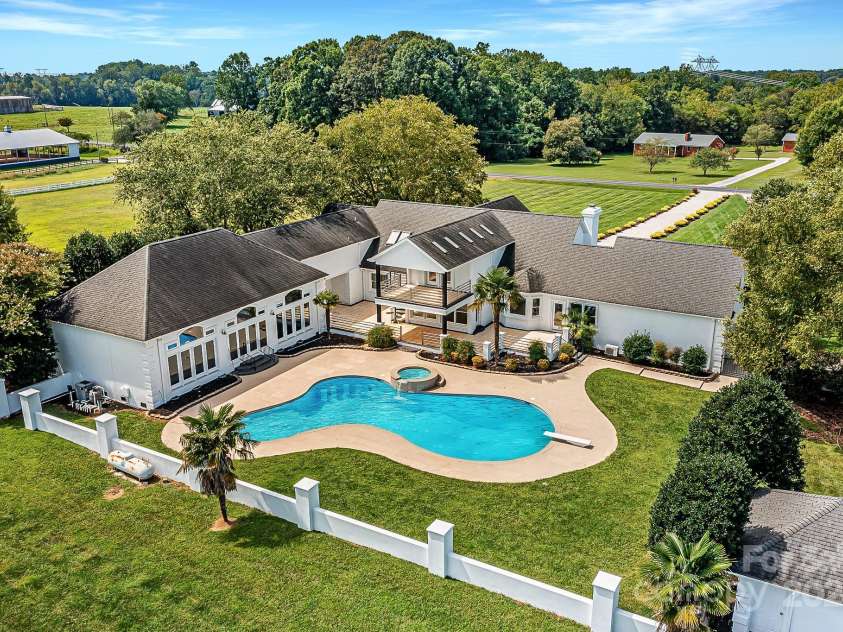 3245 Jackson Road, Mooresville, NC 28115.  MLS# CAR4161494, YatesRealty ID 13432. Spectacular, Custom, Modern, 2 Story Home with 2 Car Side Load Garage, Expansive Pool/Spa, located on 14 sprawling acres of level pasture land & surrounded by Equestrian properties!