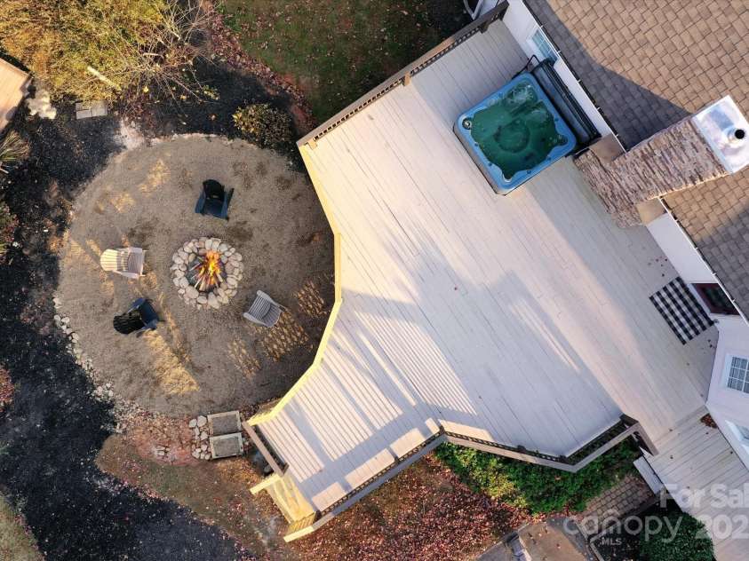 2409 Golf Course Road, Columbus, NC 28722.  MLS# CAR4318941, YatesRealty ID 13442. Aerial view of deck area with fire pit and hot tub.