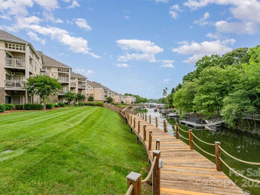 104 Pier 33 Drive, Mooresville, NC 28117.  MLS# CAR4255394, YatesRealty ID 13444. This boardwalk is lighted and stretches along behind all four buildings.