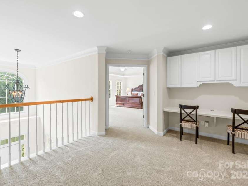 9311 St Barts Lane, Huntersville, NC 28078.  MLS# CAR4255582, YatesRealty ID 13449. Desk and cabinet storage are off the 2nd story landing with large private walk-in laundry room to the right. Primary suite entrance to the left.