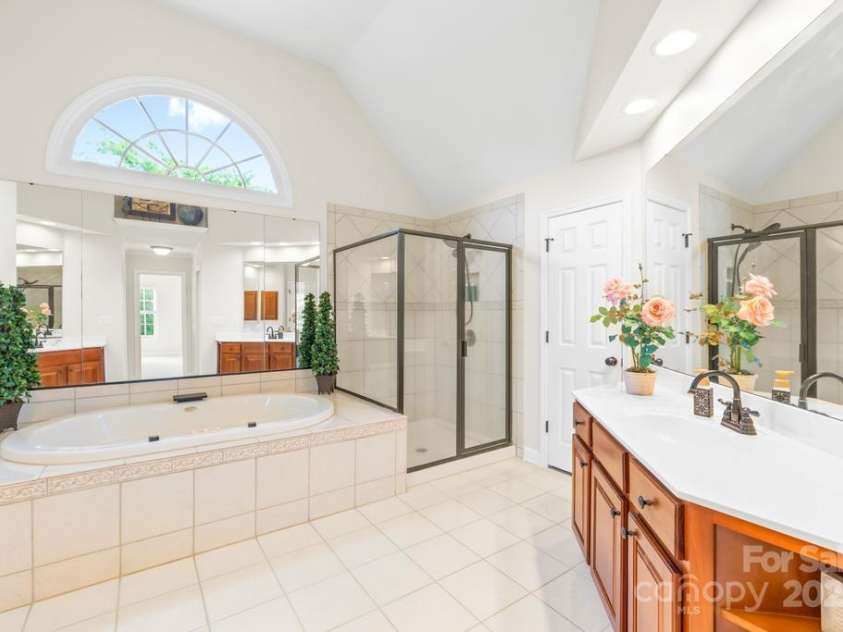 9311 St Barts Lane, Huntersville, NC 28078.  MLS# CAR4255582, YatesRealty ID 13449. Large jacuzzi tub and shower stall - also private water closet. Lots of natural light and counter space in the dual vanities too!