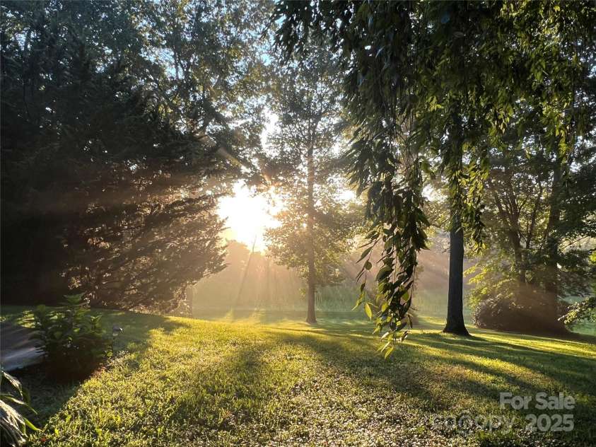 336 Winding Way Lane, Hendersonville, NC 28792.  MLS# CAR4202529, YatesRealty ID 13459. Sunset in the back yard