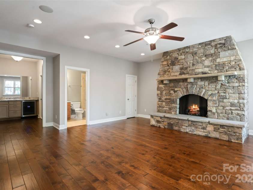 11 La Rue Court, Candler, NC 28715.  MLS# CAR4242161, YatesRealty ID 13467. Lower Level family room complete with beautiful stone fireplace and full bathroom