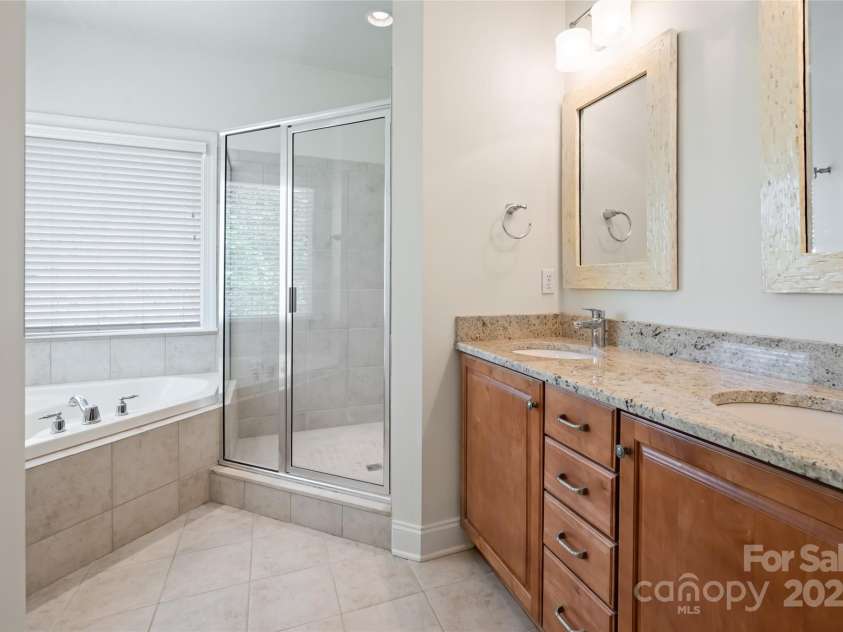 11 La Rue Court, Candler, NC 28715.  MLS# CAR4242161, YatesRealty ID 13467. Primary Bathroom and 2 closets with upgraded closet systems complete the primary suite