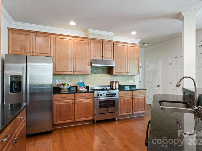 11 La Rue Court, Candler, NC 28715.  MLS# CAR4242161, YatesRealty ID 13467. Tasteful kitchen with stainless appliances and an Italian Bertazzoni oven for serious cooks!