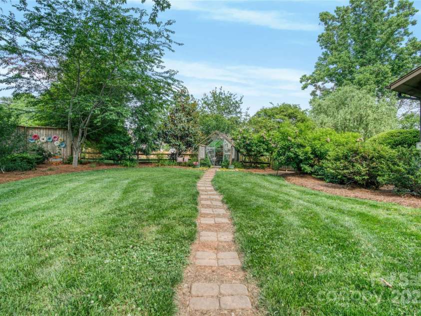 10315 Washam Potts Road, Cornelius, NC 28031.  MLS# CAR4243746, YatesRealty ID 13468. Path to greenhouse