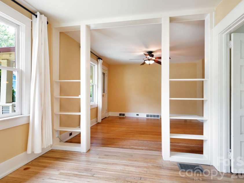 30 Monroe Place, Asheville, NC 28801.  MLS# CAR4366107, YatesRealty ID 13481. Built-In Shelving Separates Living Room from Office