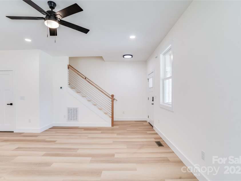 7 Jetts Ridge Drive, Swannanoa, NC 28778.  MLS# CAR4222038, YatesRealty ID 13487. Utility closet with Hot water tank is located under the stairs.