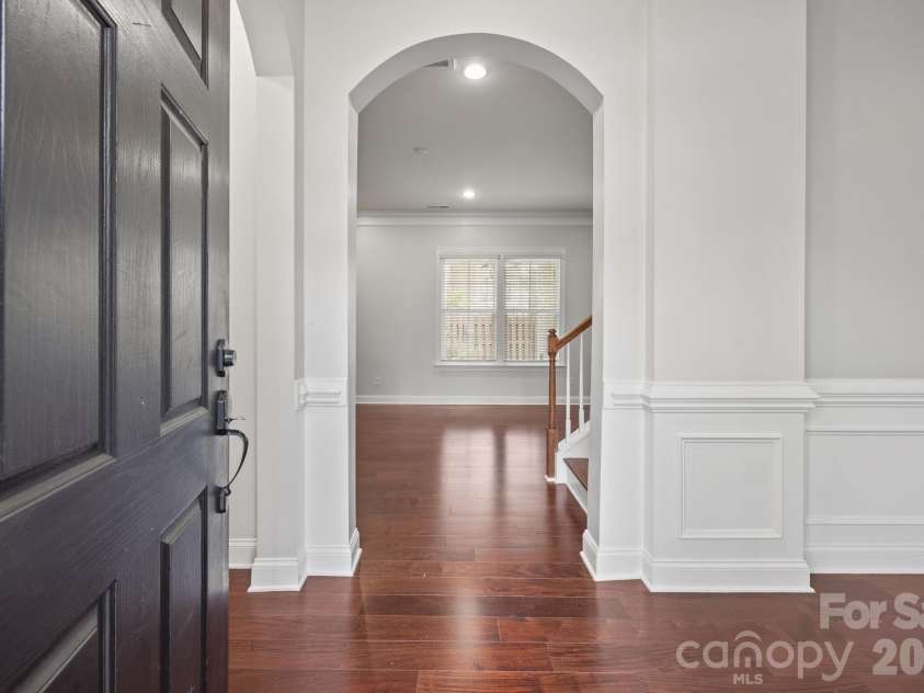 821 Herrin Avenue, Charlotte, NC 28205.  MLS# CAR4341670, YatesRealty ID 13492. Elevated interiors featuring arched transitions and classic wainscotting, giving the home a custom, high-end feel.