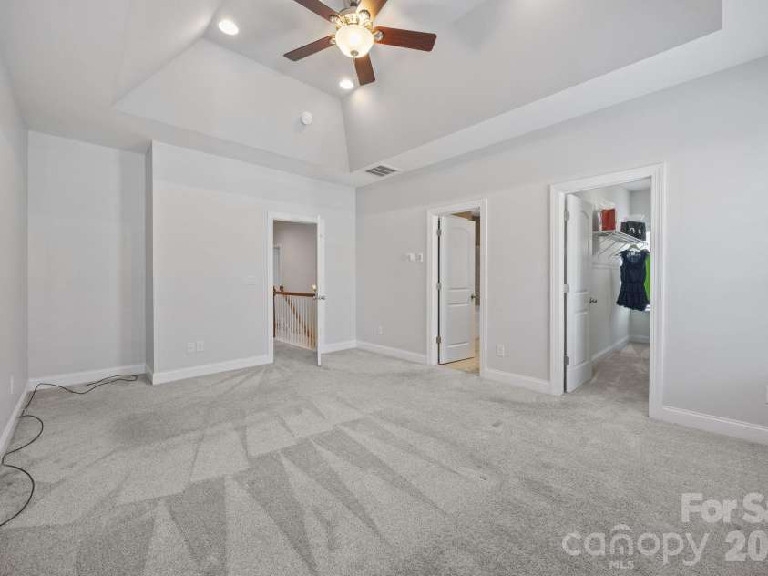 821 Herrin Avenue, Charlotte, NC 28205.  MLS# CAR4341670, YatesRealty ID 13492. The primary suite is a true standout, featuring a dramatic vaulted tray ceiling that adds volume and luxury. 
