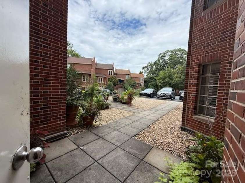 301 10th Street, Charlotte, NC 28202.  MLS# CAR4299886, YatesRealty ID 13498. Side entrance from hallway leads to gated parking lot and patio.