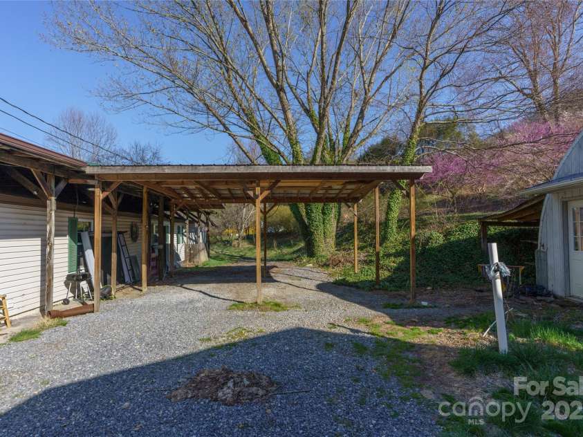 51 Ferguson Lane, Maggie Valley, NC 28751.  MLS# CAR4242031, YatesRealty ID 13499. 2 car carport next to quonset hut