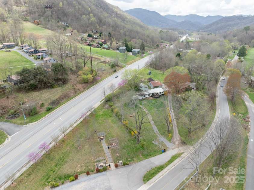 51 Ferguson Lane, Maggie Valley, NC 28751.  MLS# CAR4242031, YatesRealty ID 13499. Drone looking at the Hwy access to this property - city park in front.