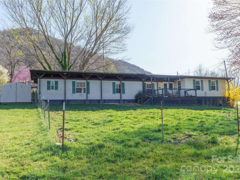 51 Ferguson Lane, Maggie Valley, NC 28751.  MLS# CAR4242031, YatesRealty ID 13499. Fenced yard and covered porch