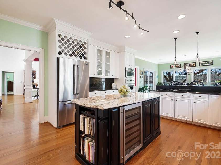 6403 Amos Smith Road, Charlotte, NC 28214.  MLS# CAR4233233, YatesRealty ID 13507. Engage your inner chef in the eat-in gourmet kitchen, equipped w/ ss appliances, gas cooktop, wall oven, Viking oven, center island, breakfast bar, wine cooler, & 2 pantries with the lake view as your backdrop
