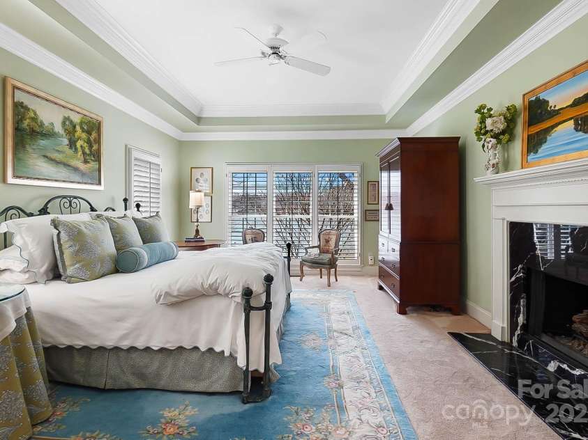 6403 Amos Smith Road, Charlotte, NC 28214.  MLS# CAR4233233, YatesRealty ID 13507. Retreat to the luxurious primary suite on the main floor w/ fireplace, built-in cabinetry, and spa-like bathroom offers a sanctuary for relaxation and rejuvenation
